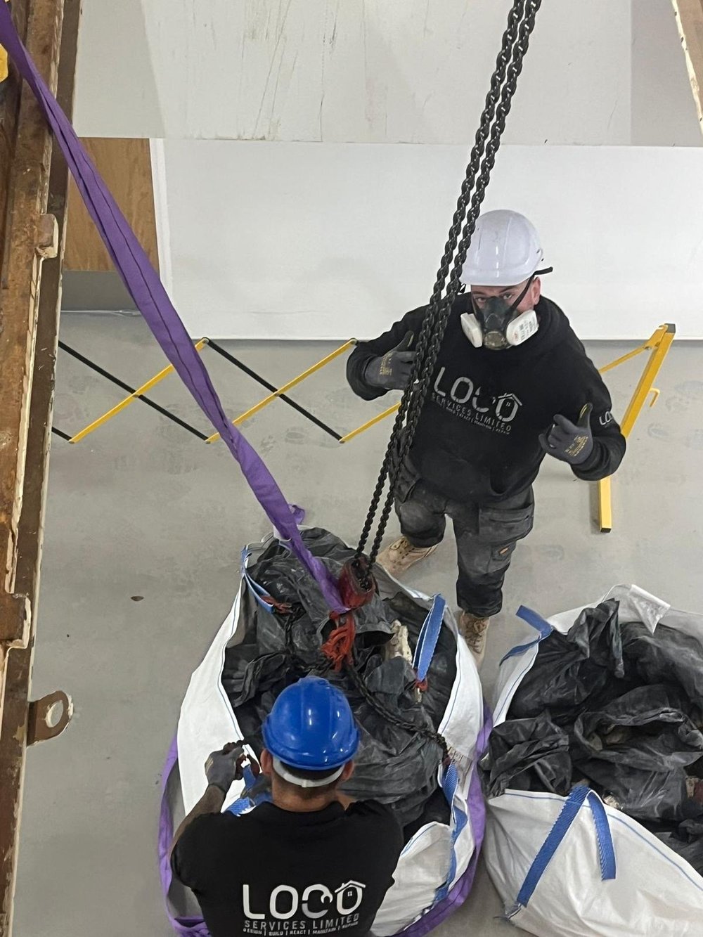 LOCO team members working with lifting equipment during building works
